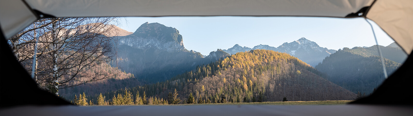 A mountain view shot from within a roof tent